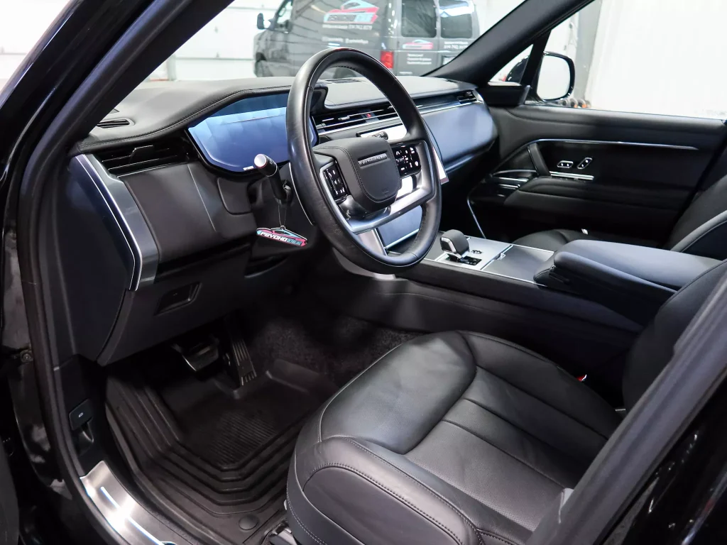 Interior car detailing result showing clean front passenger seat and refreshed surfaces